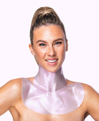 A woman using a Diamond Radiance Neck and Decollete Mask Combo.