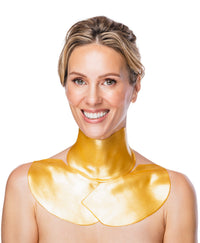 A woman using a Nano Gold Repair Neck and Decollete Mask.